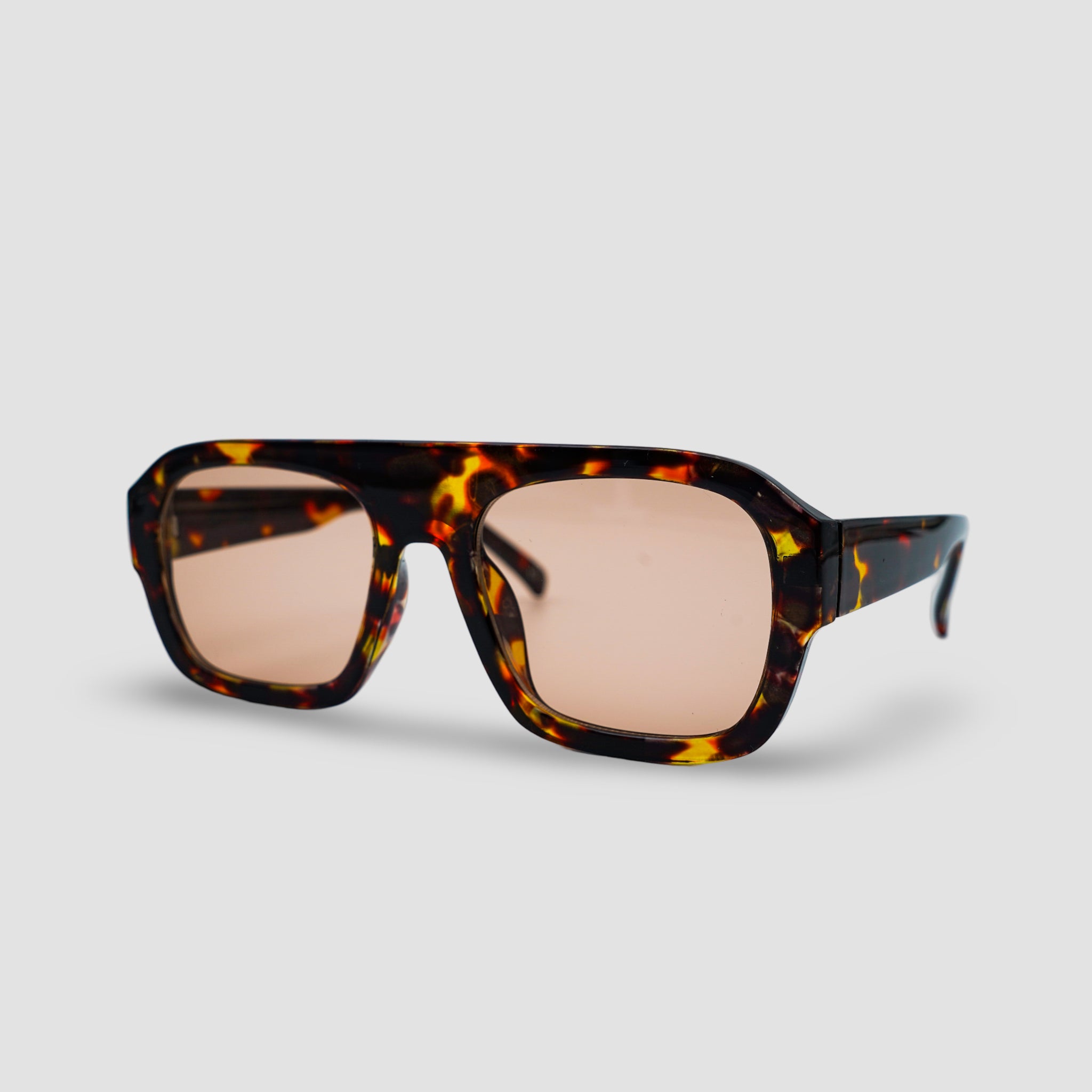 Stijlvolle zonnebril met schildpadpatroon en roze glazen, perfect voor een modieuze look.