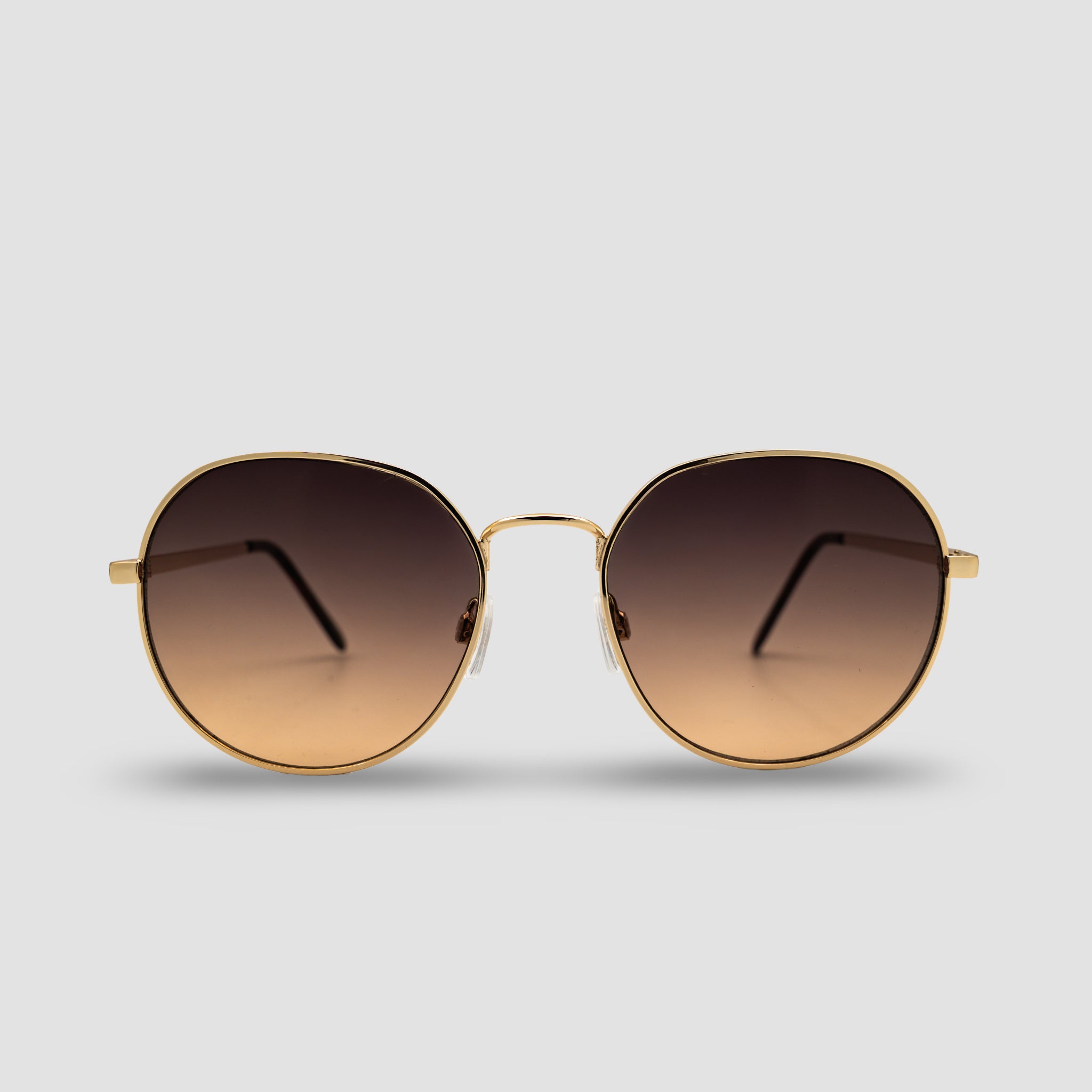 Stijlvolle ronde zonnebril met gouden montuur en bruine gradient glazen