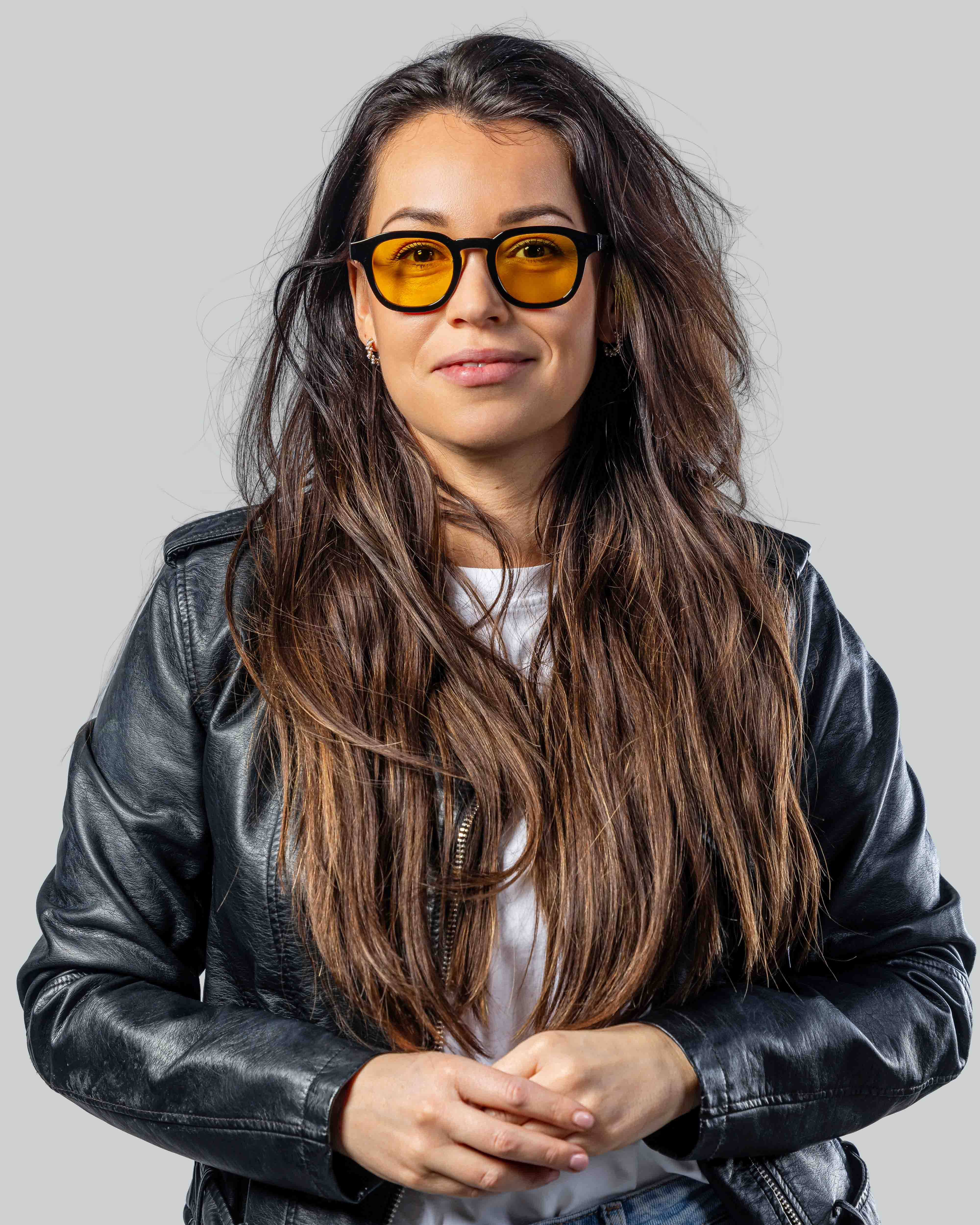 Vrouw met stijlvolle zonnebril met gele glazen en zwarte montuur, perfect voor een modieuze look.