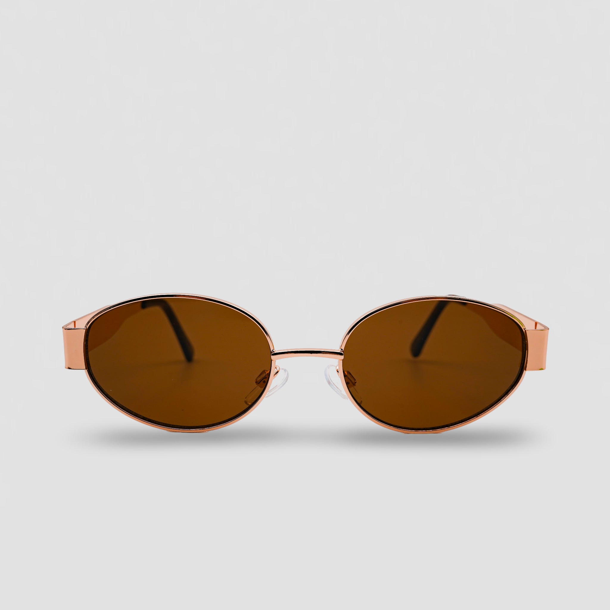 Stijlvolle zonnebril met rosegouden montuur en bruine glazen, perfect voor een modieuze look.