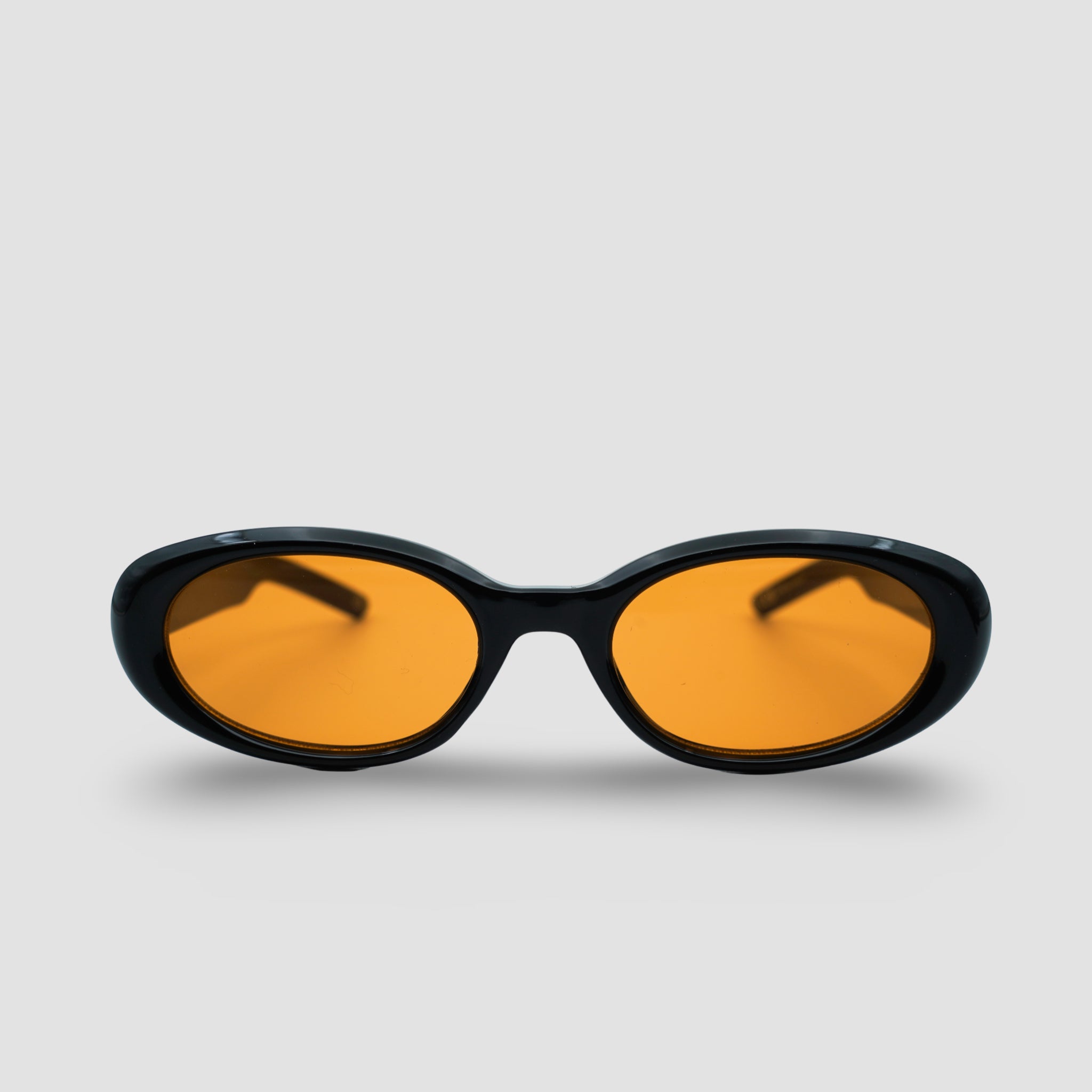 Stijlvolle zonnebril met zwarte montuur en oranje glazen, perfect voor een trendy look.
